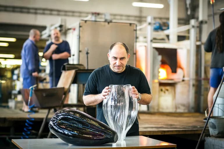 Jaroslav Bejvl Jr. with a hand-blown crystal object in the glassworks